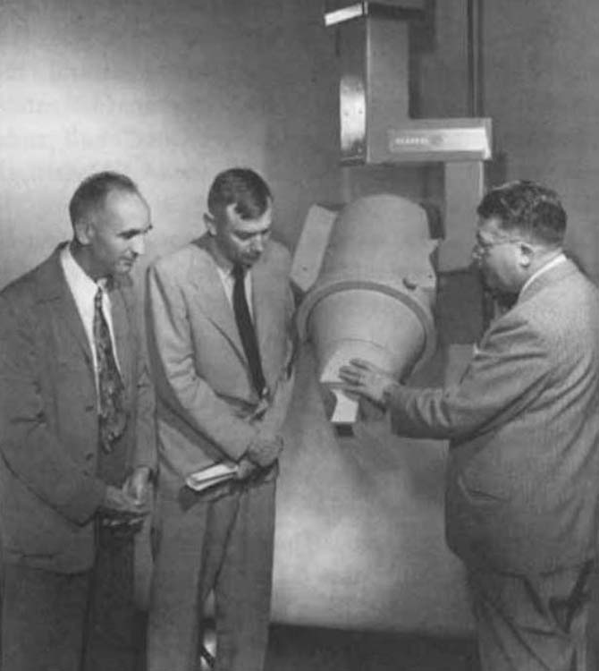 Drs. Fletcher, Brucer, and Dale Trout, General Electric physicist, with the Co-60 unit designed for M.D. Anderson in June 1951